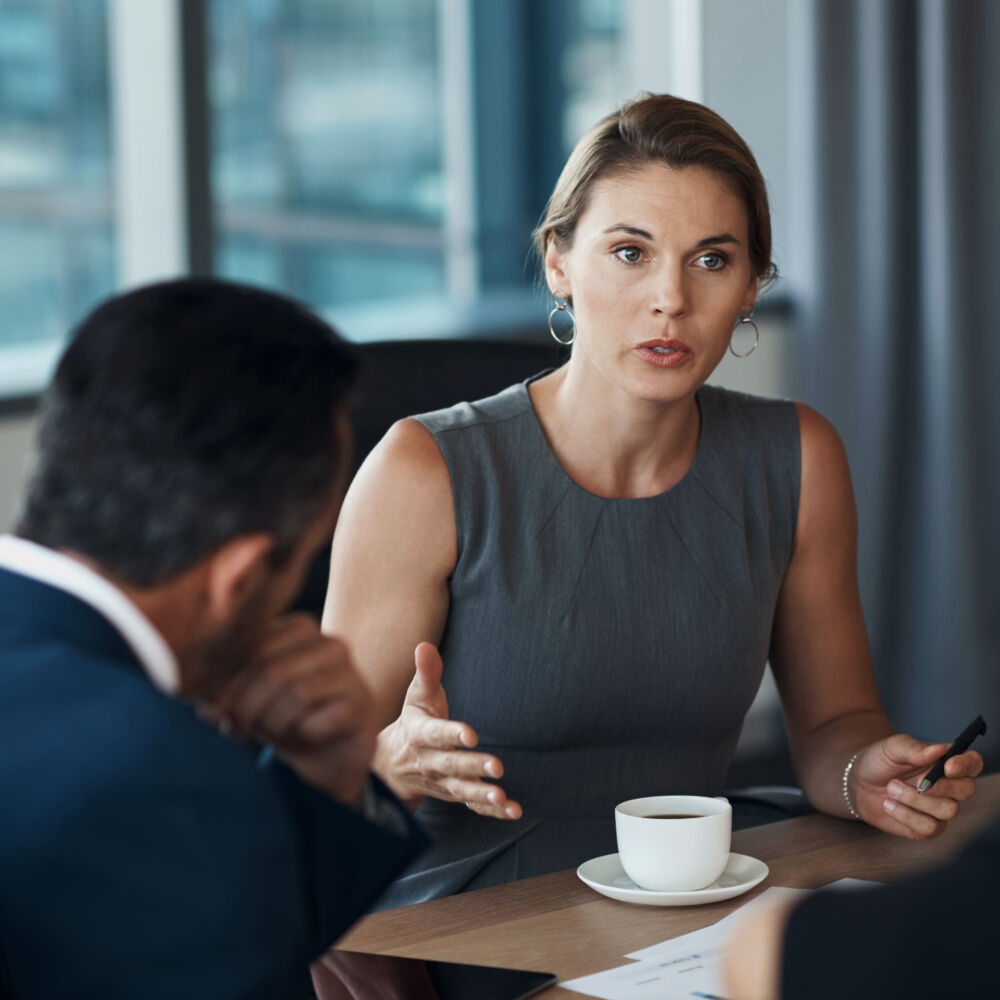 Serious woman talking to business clients in meeting negotiation, legal advice or professional advisory planning. Lawyer, manager or corporate people in conference room discussion for career strategy